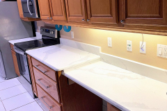 grey kitchen cabinets with black granite countertops