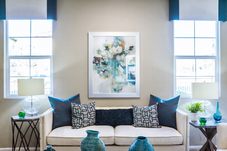 Modern living room with blue accents and abstract art.