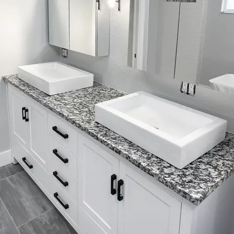 Modern double vanity bathroom sink and cabinets.