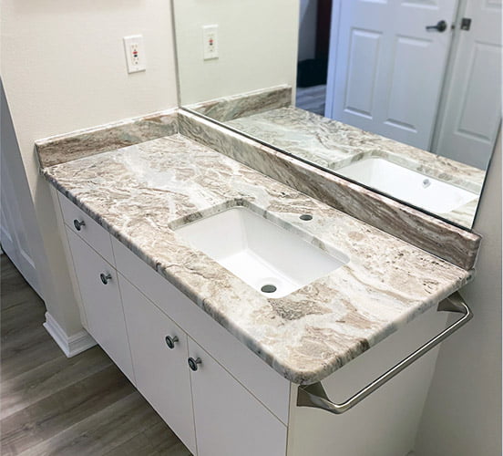 Modern double vanity bathroom sink with granite countertop.