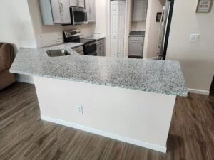 Granite kitchen island with sink.