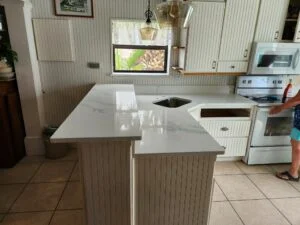 White kitchen with marble countertops and oven