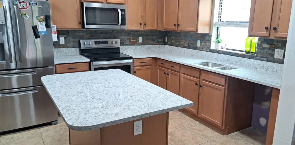 Modern kitchen with marble countertops.