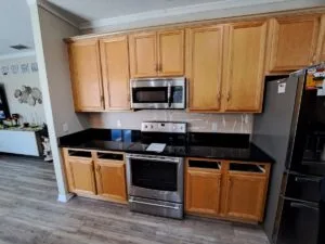 Modern kitchen with wooden cabinets and appliances.