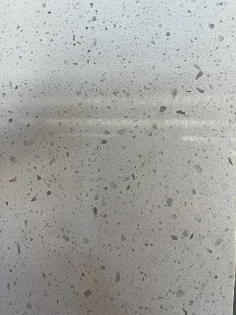 Close-up of speckled white stone surface texture.