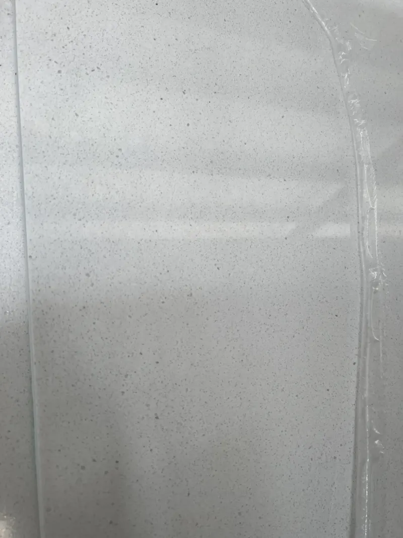 Close-up of textured gray surface with plastic wrap.