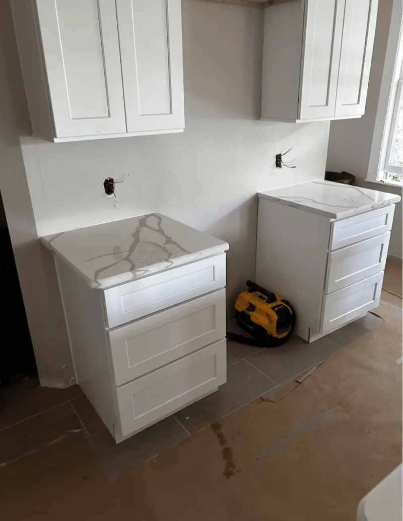 White kitchen cabinets under installation
