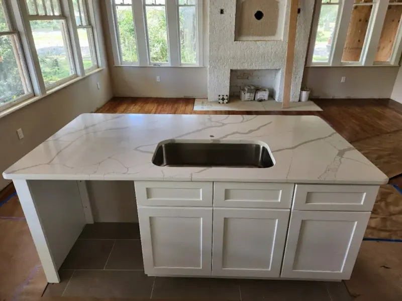 Modern kitchen island with marble countertop.