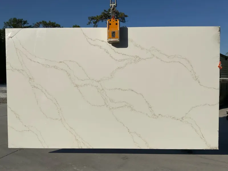 Large white marble slab with veins outdoors.