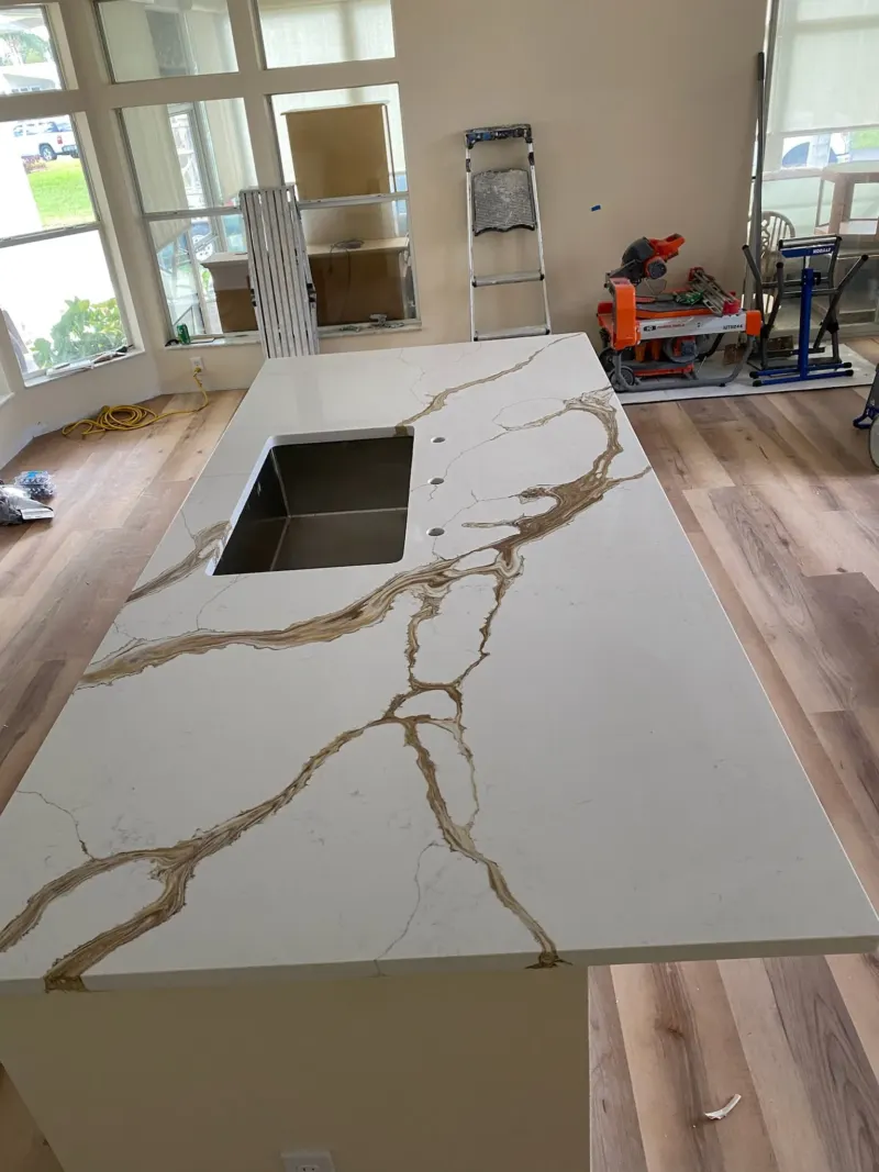 Kitchen countertop installation with visible tools and equipment.
