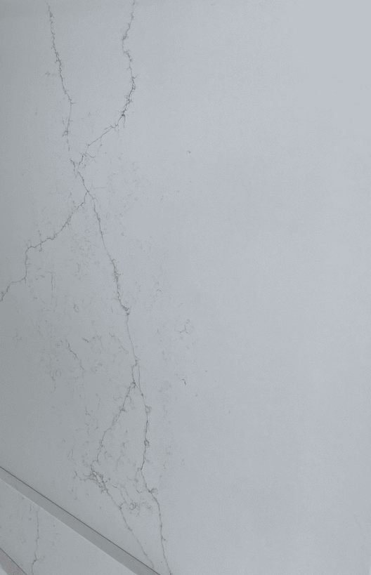 Cracked white painted wall close-up view.