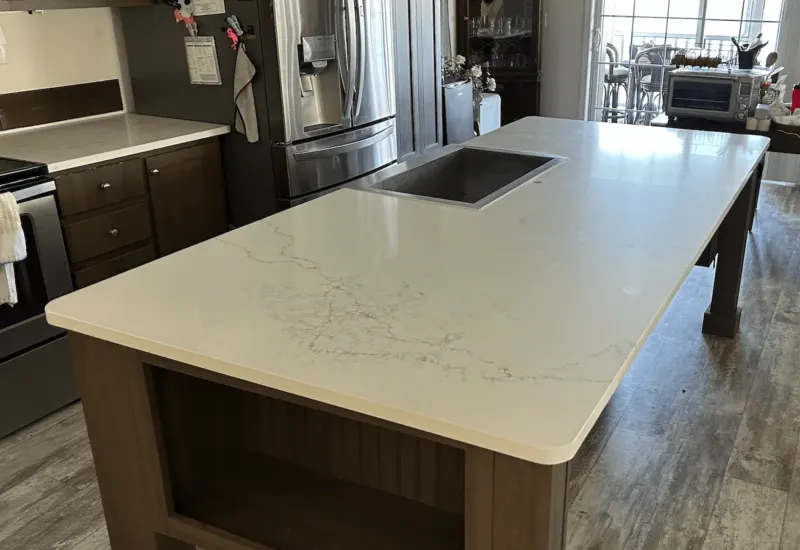 Modern kitchen with a marble island countertop.
