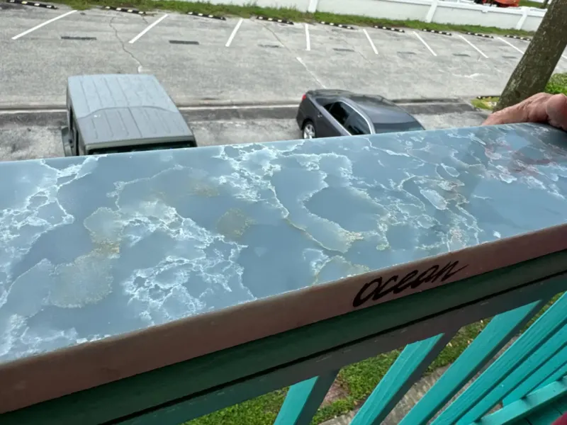 Marble countertop with ocean design on balcony.