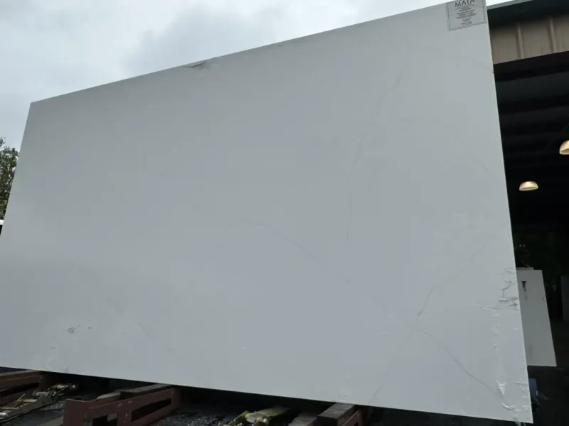 Large white stone slab outdoors near warehouse