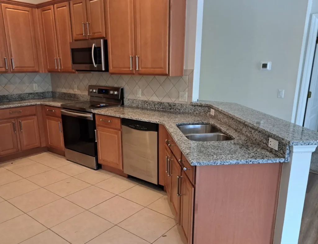 Modern kitchen with wooden cabinets and granite countertops.