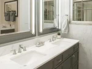 Modern bathroom with double sinks and large mirrors.
