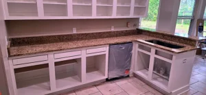 Finished kitchen with heavily veined Gedony granite countertops where slab patterns flow continuously across the seams