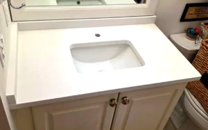 Carrara Total White quartz vanity top installed in a bright Orlando bathroom by EdStone, a branded engineered quartz surface