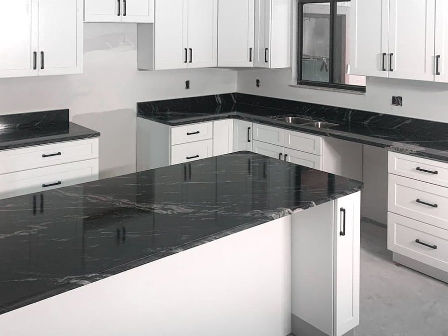 Black granite kitchen countertops with white shaker cabinets installed by EdStone in Orlando
