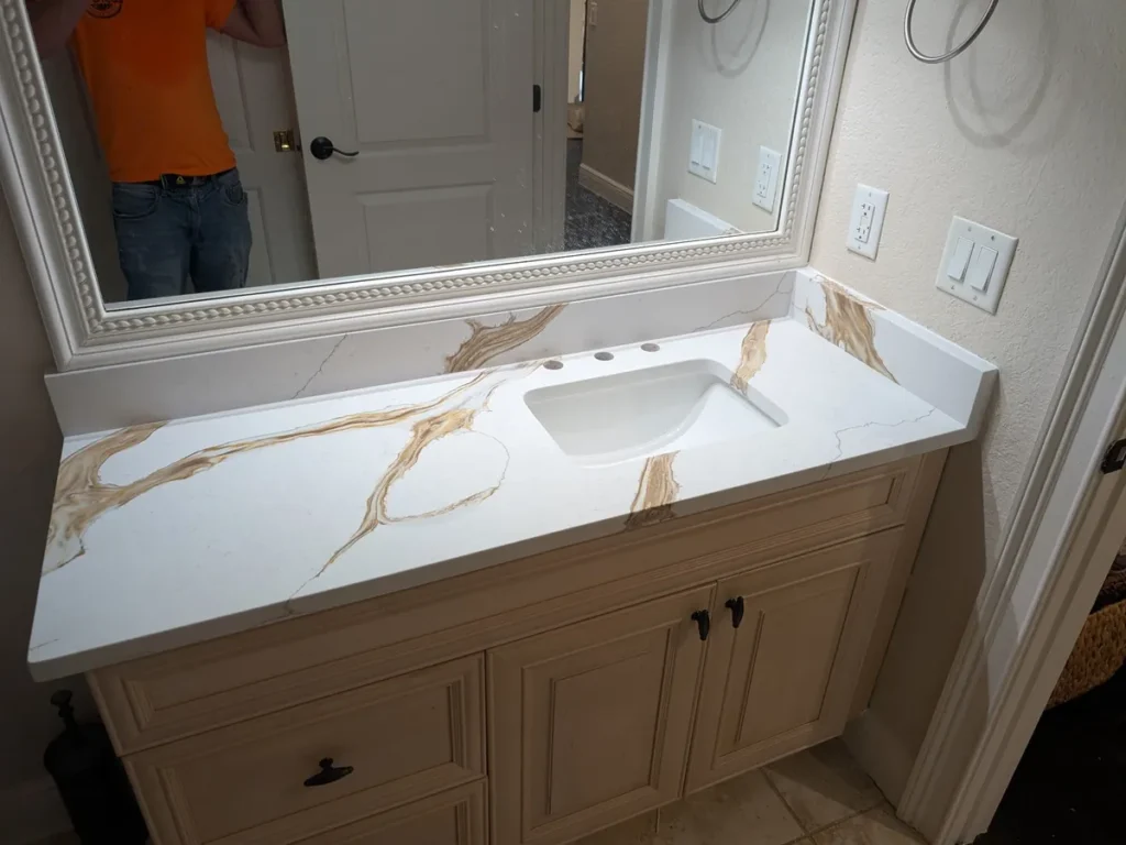 Same bathroom after installing Calacatta Dragon quartz with gold veining