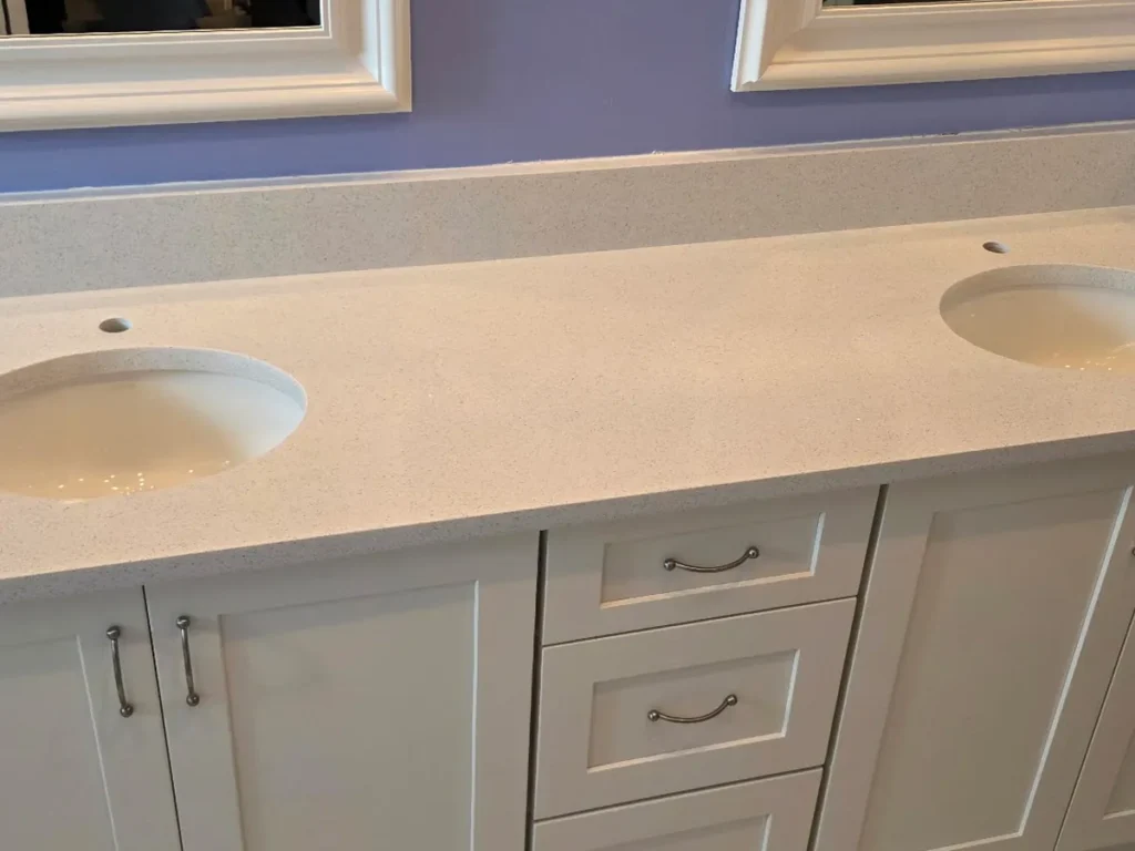 Same double-sink bathroom after installing Sparkling White quartz with undermount sinks