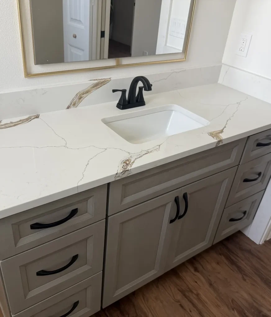 Calacatta Dragon quartz bathroom countertop with undermount sink and black faucet, installed by EdStone in Orlando