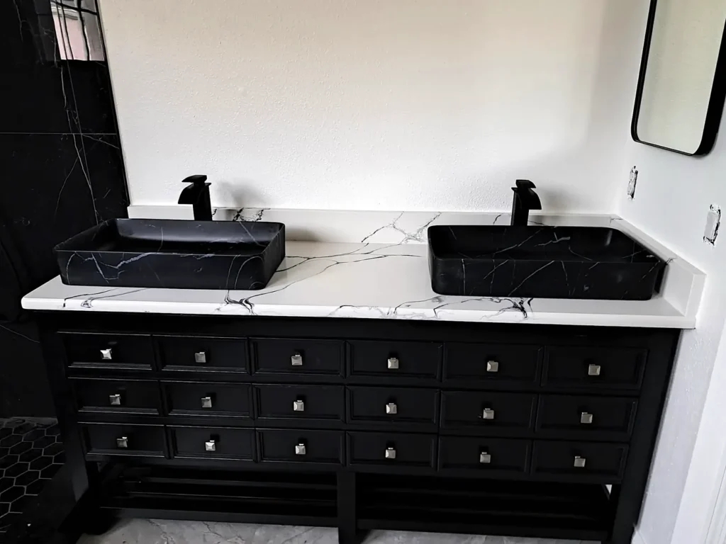 Calacatta Midnight Lake quartz double-sink bathroom countertop with black vessel sinks and faucets