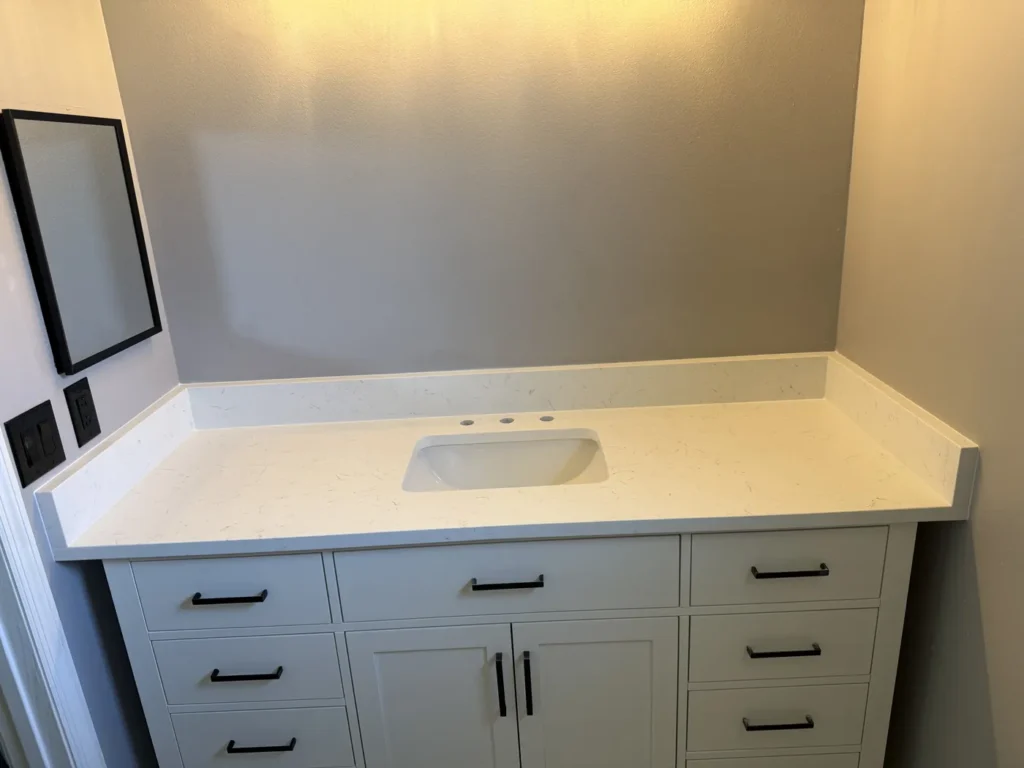 Carrara Jax quartz bathroom countertop with side splashes